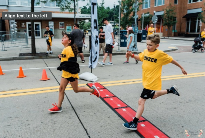 Runners Crossing the Finish Line at the Yinzer 4.12K